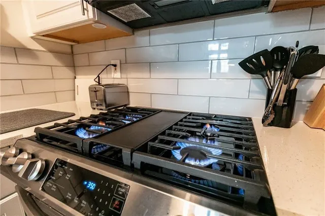 a stove top oven sitting inside of a kitchen
