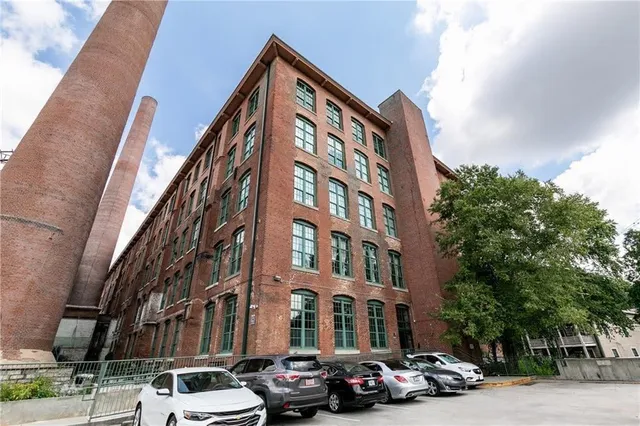 a couple of cars parked in front of brick building