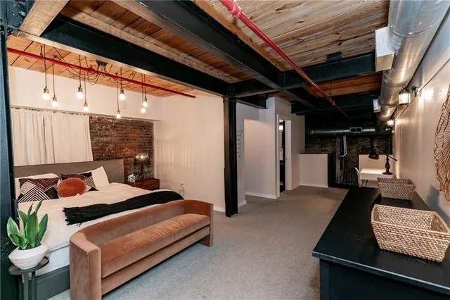 a bedroom with a bed and a mirror