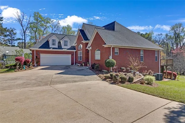 a view of a house with yard and sitting area