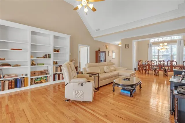 a living room with furniture and a book shelf