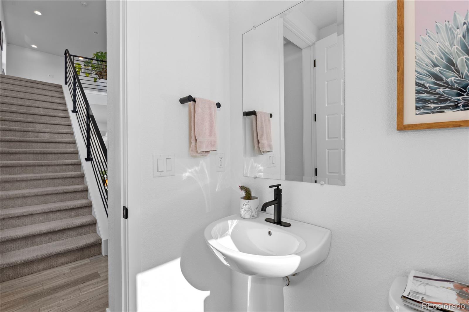 6058 North Perth Street Aurora, CO 80019 - Photo 23 of 47 a bathroom with a sink and a mirror