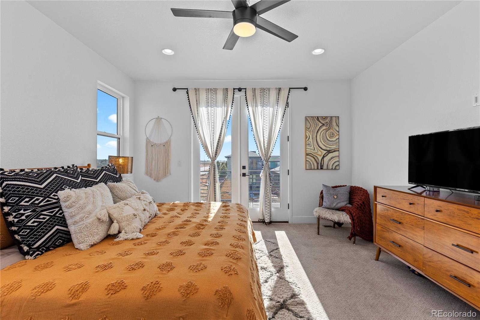 6058 North Perth Street Aurora, CO 80019 - Photo 27 of 47 a bedroom with furniture and a flat screen tv