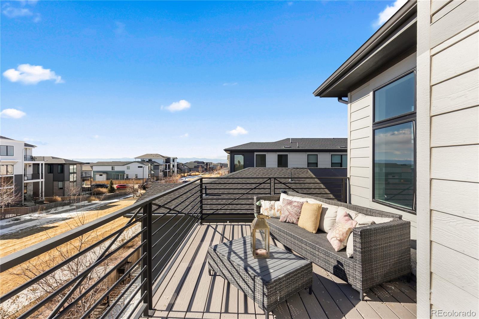 6058 North Perth Street Aurora, CO 80019 - Photo 30 of 47 a view of a balcony with two chairs and a table