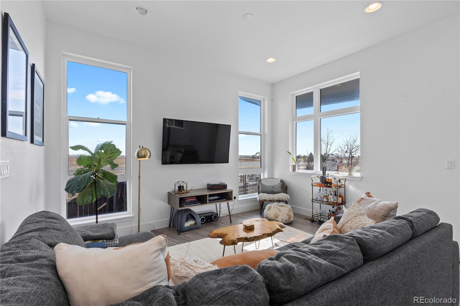 6058 North Perth Street Aurora, CO 80019 - Photo 8 of 47 a living room with furniture and a flat screen tv