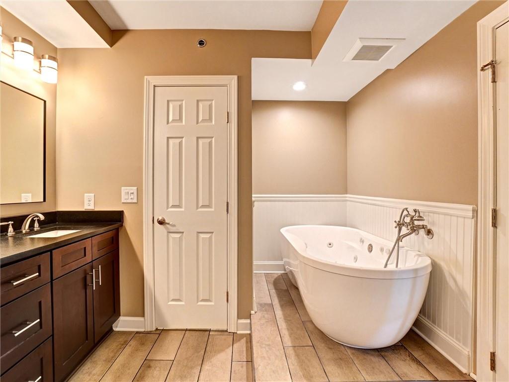3435 Kingsboro Road Northeast, Unit 1601 Atlanta, GA 30326 - Photo 21 of 54 a bathroom with a bathtub and shower