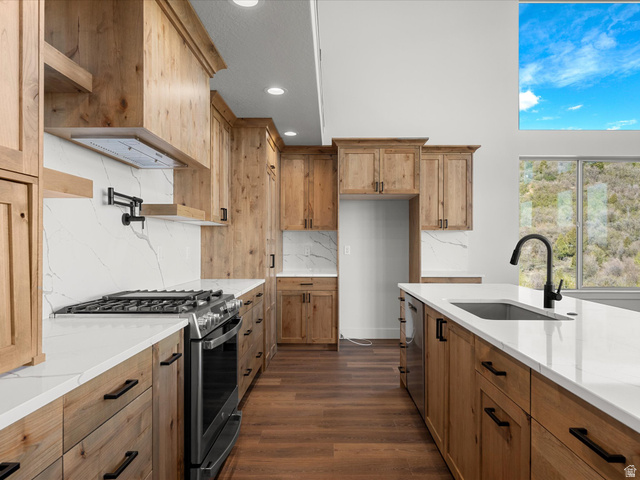1159 North Broad Hollow Road Garden City, UT 84028 - Photo 15 of 55 Gourmet kitchen featuring wood-finish cabinetry, white countertops, and full-height backsplash