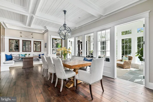 a view of a dining room with furniture wooden floor and chandelier