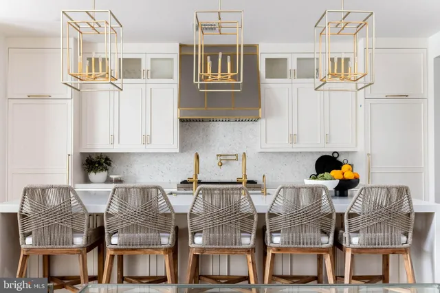 a kitchen with stainless steel appliances granite countertop a stove and white cabinets