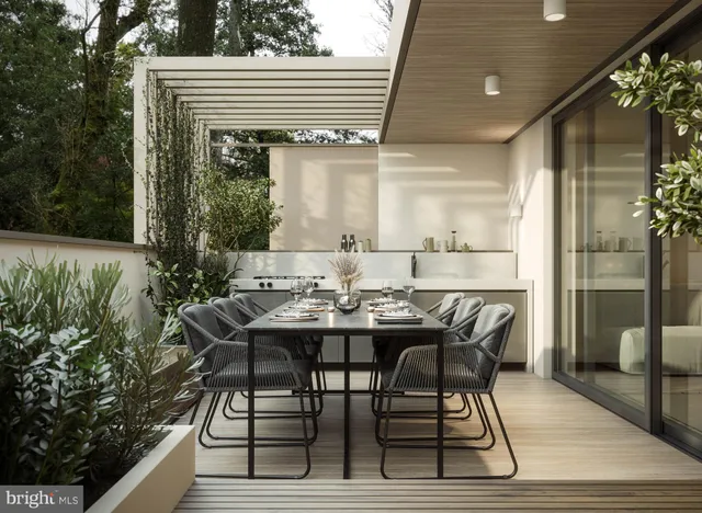 a view of a patio with table and chairs with wooden floor and plants