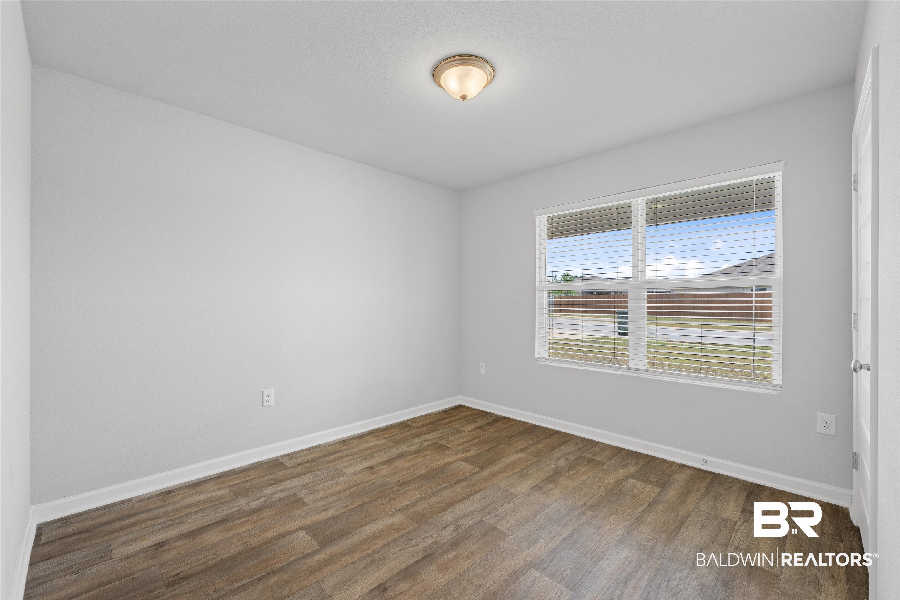 7457 Brompton Drive Foley, AL 36535 - Photo 16 of 24 Unfurnished room with baseboards and dark wood finished floors