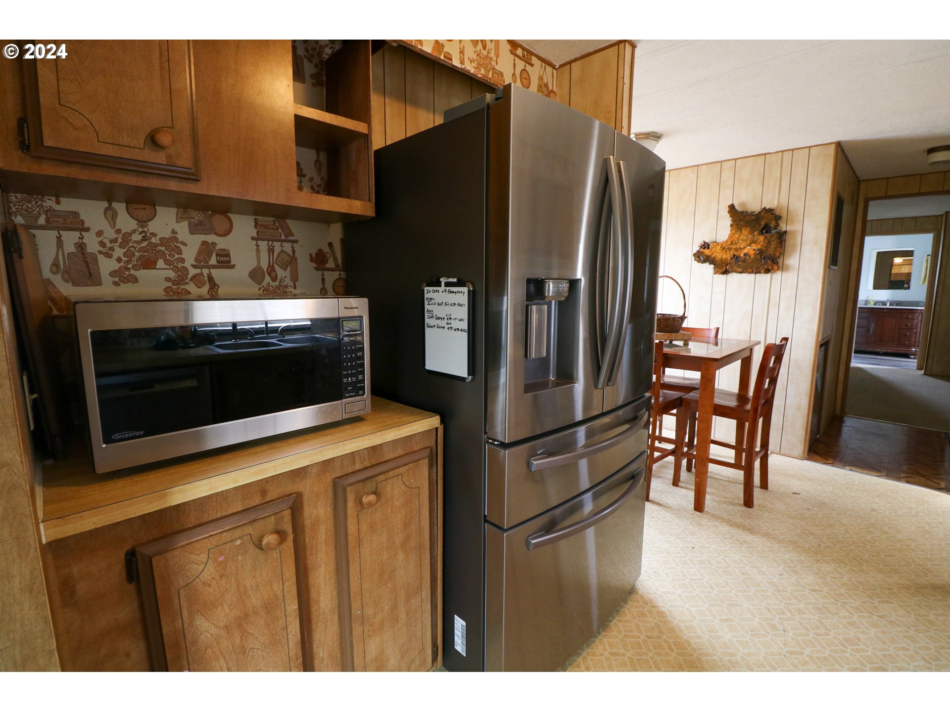 1265 Embarcadero Circle Coos Bay, OR 97420 - Photo 12 of 36 a kitchen with stainless steel appliances kitchen island granite countertop a refrigerator a stove and a sink