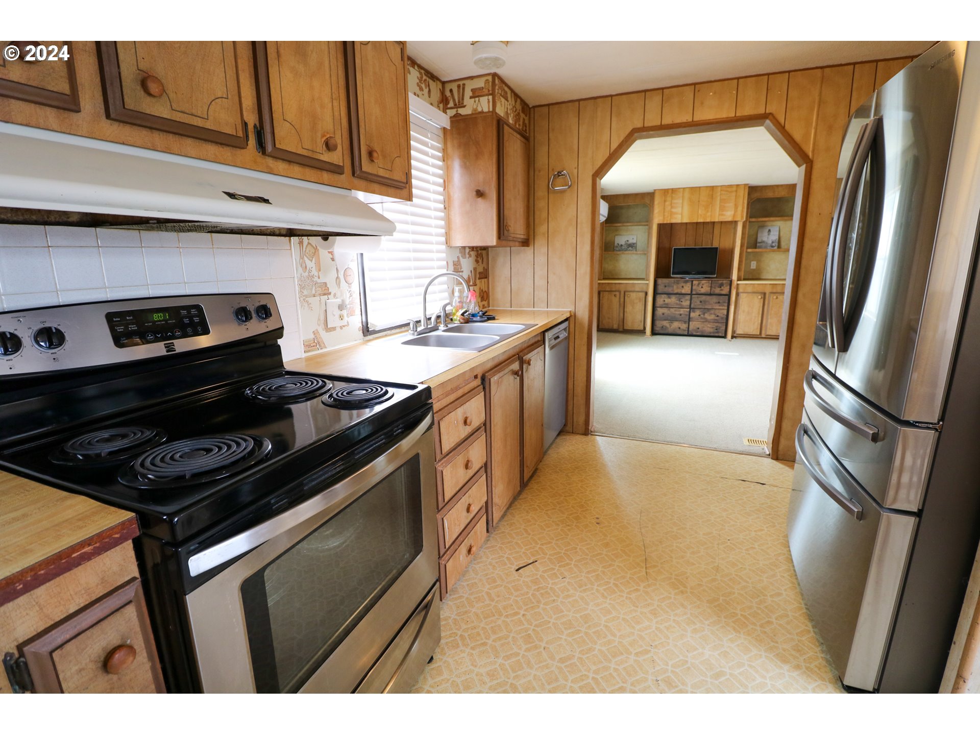 1265 Embarcadero Circle Coos Bay, OR 97420 - Photo 13 of 36 a kitchen with stainless steel appliances granite countertop a stove a refrigerator and a sink