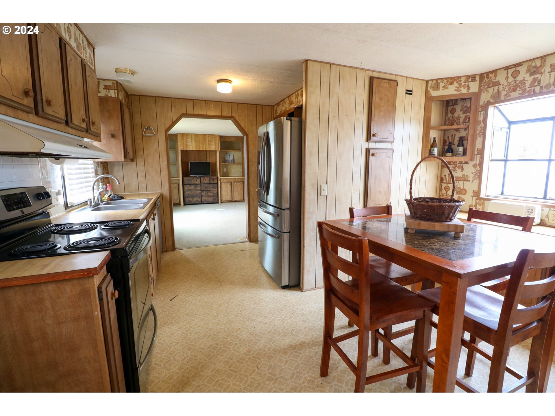 1265 Embarcadero Circle Coos Bay, OR 97420 - Photo 15 of 36 a kitchen with stainless steel appliances granite countertop a table chairs and a refrigerator