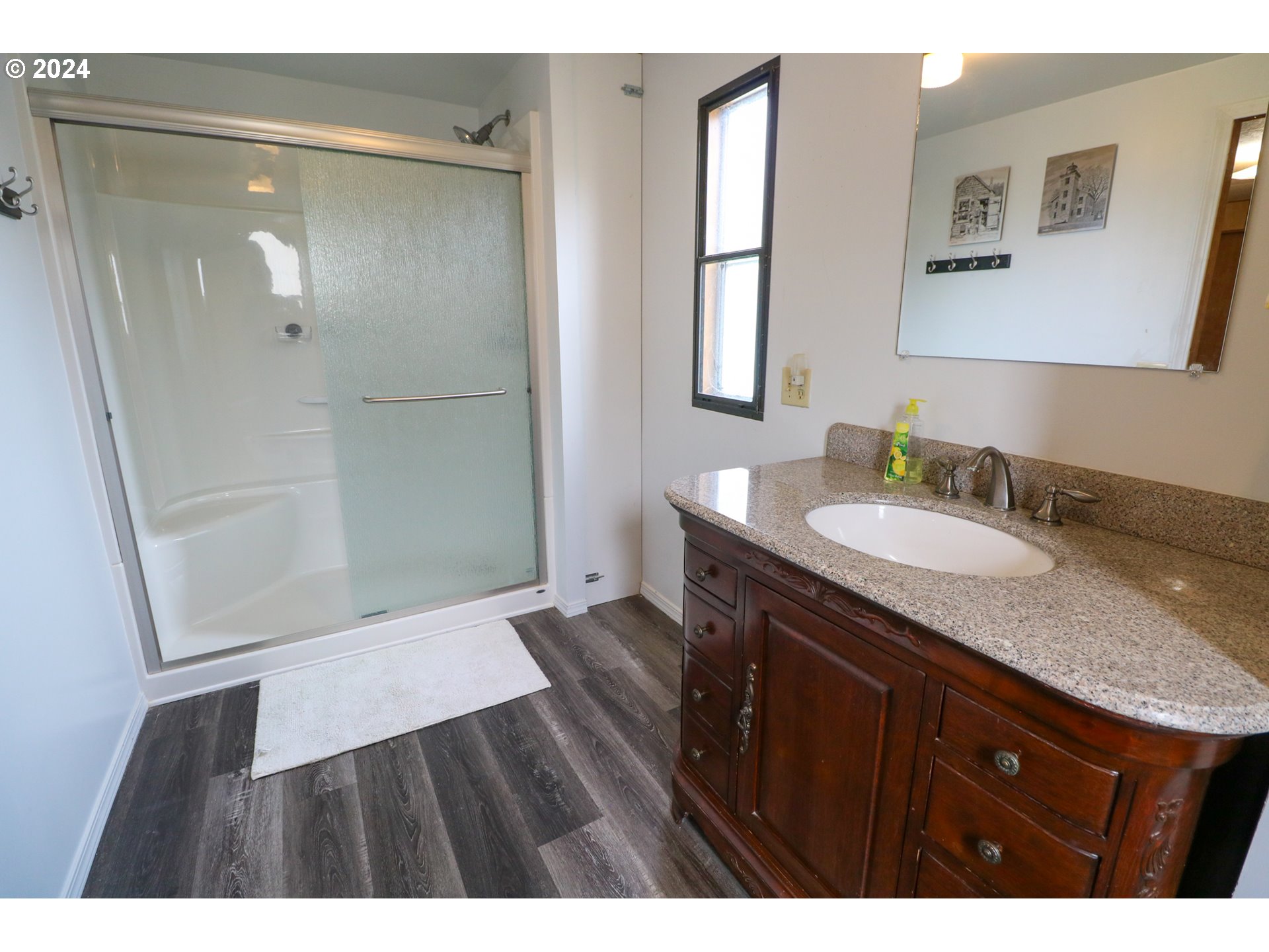 1265 Embarcadero Circle Coos Bay, OR 97420 - Photo 20 of 36 a bathroom with a granite countertop sink shower and a mirror