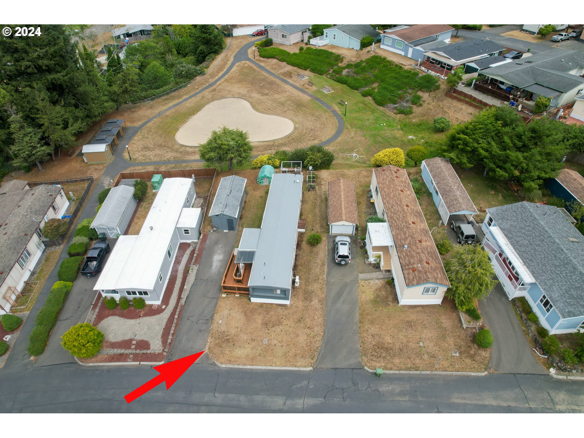 1265 Embarcadero Circle Coos Bay, OR 97420 - Photo 34 of 36 an aerial view of a house with a swimming pool
