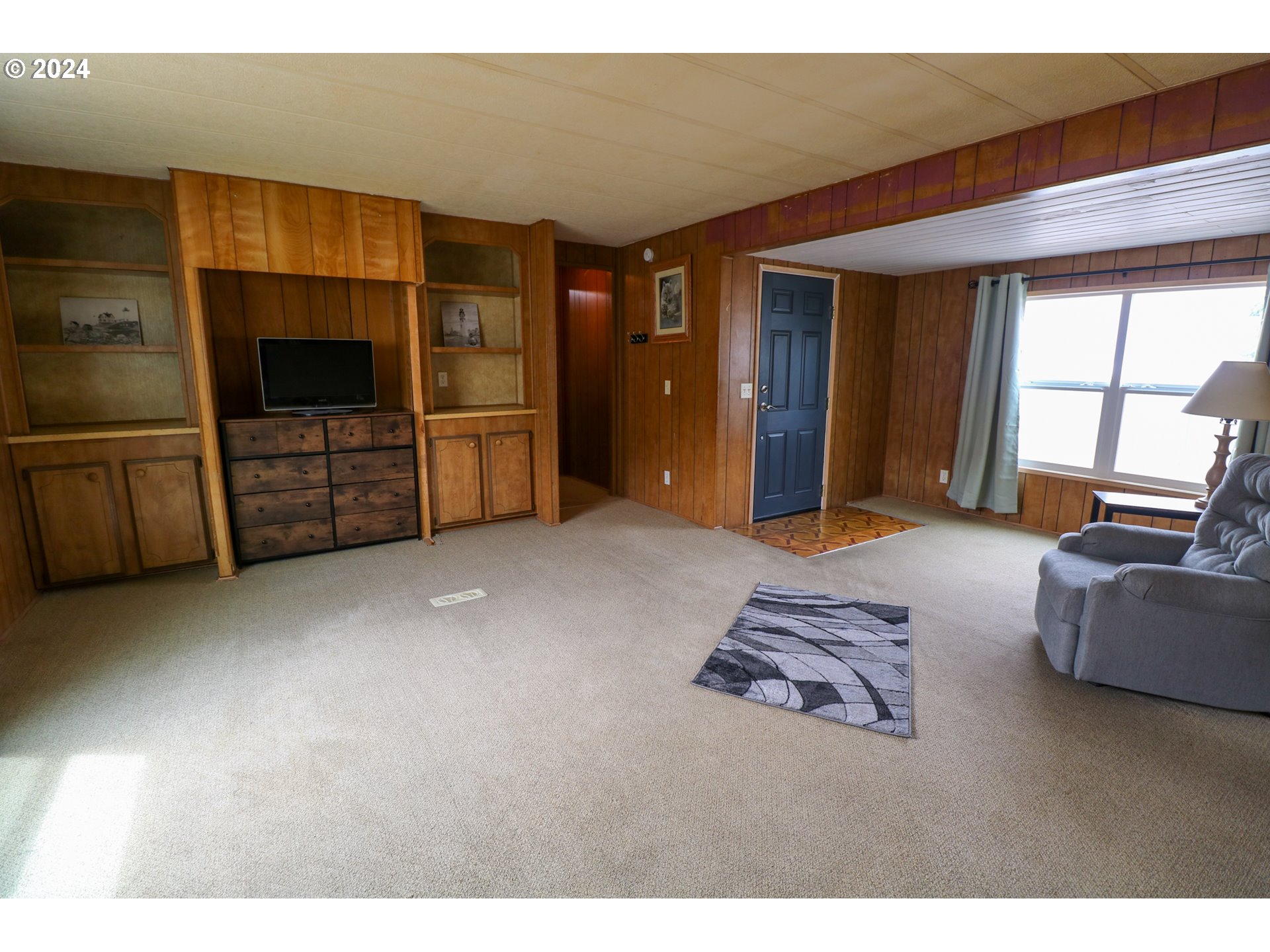 1265 Embarcadero Circle Coos Bay, OR 97420 - Photo 8 of 36 a living room with furniture and a flat screen tv