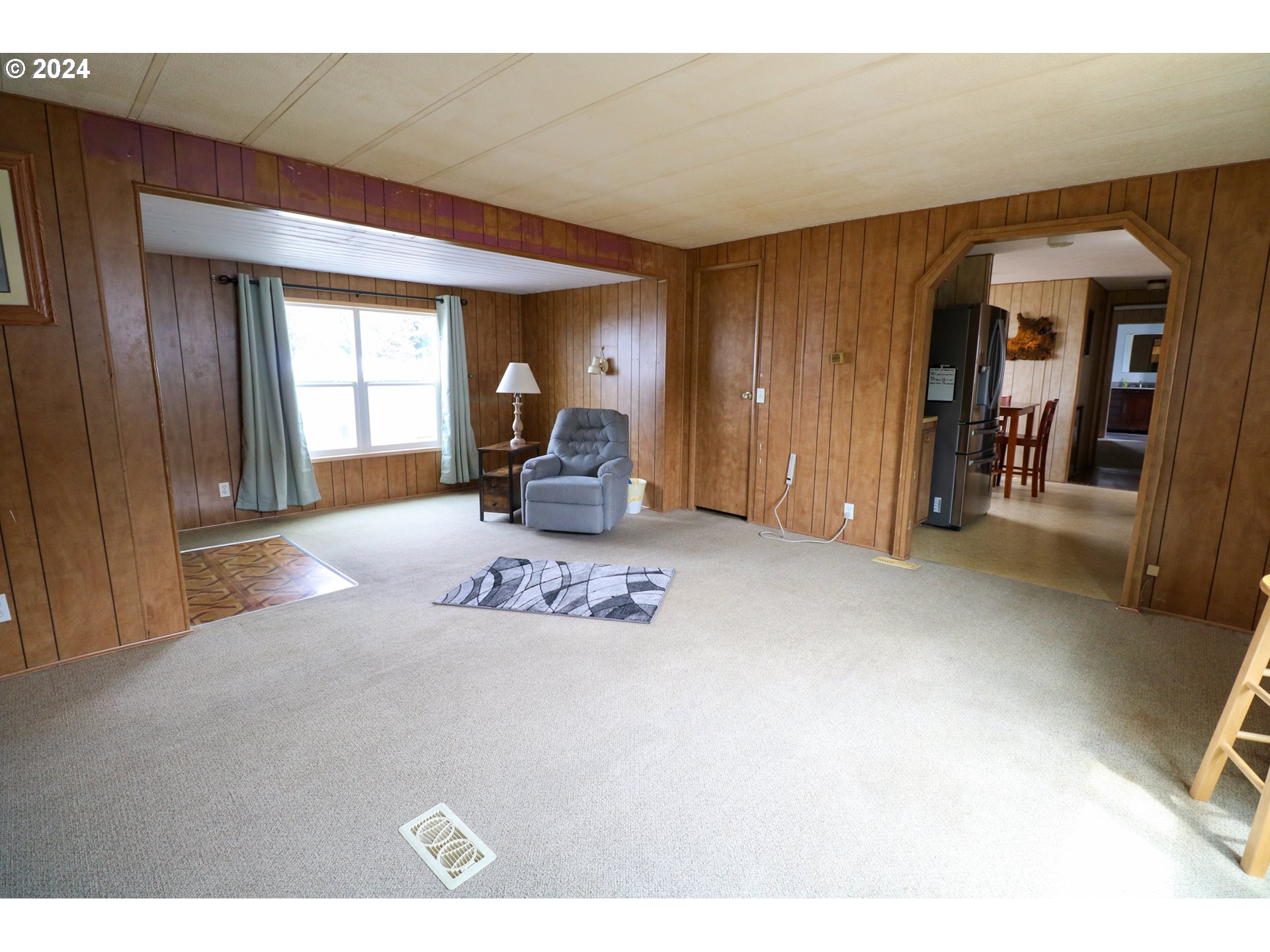 1265 Embarcadero Circle Coos Bay, OR 97420 - Photo 10 of 36 a living room with furniture a window and a flat screen tv