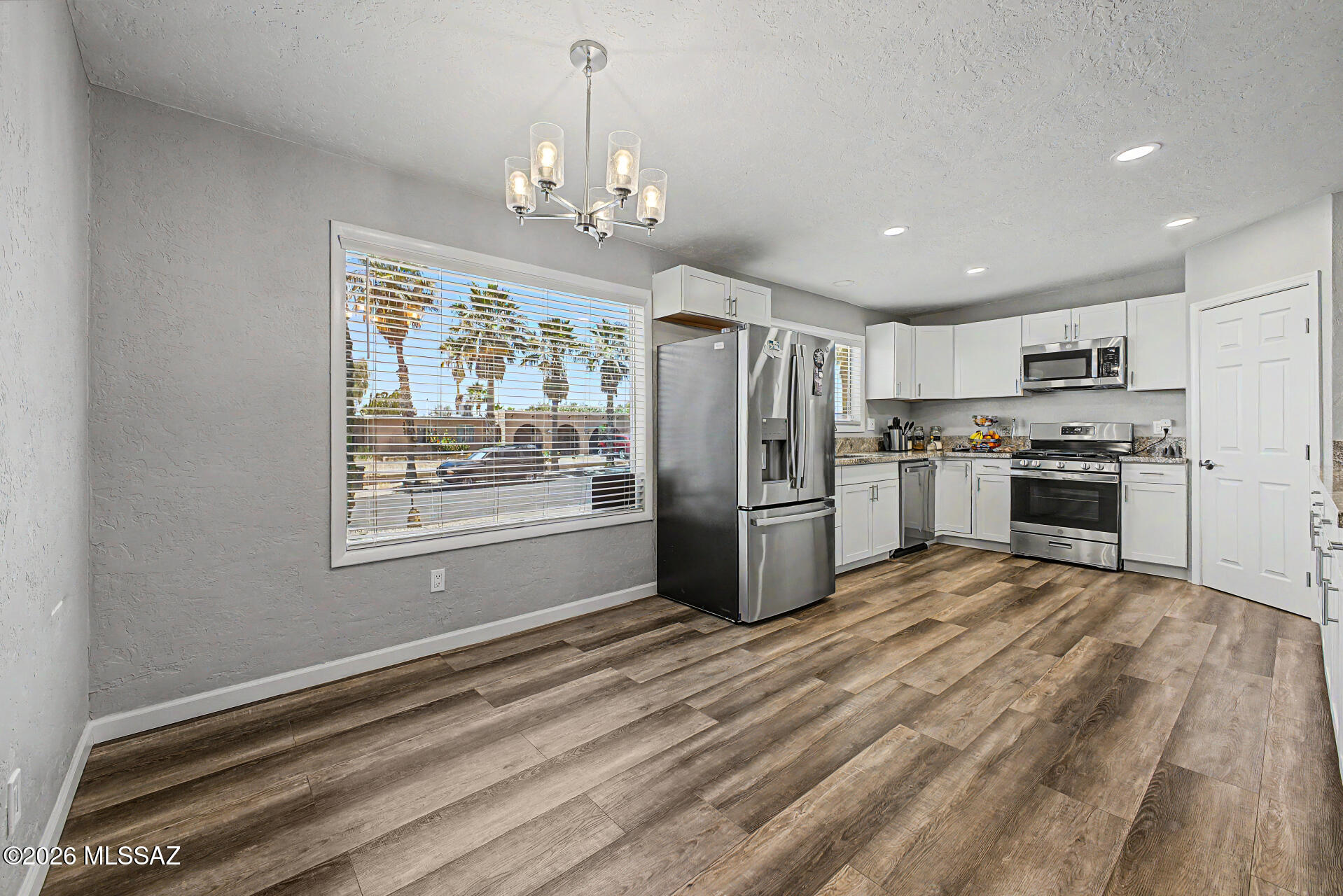 3249 South Serena Circle Tucson, AZ 85730 - Photo 9 of 27 Kitchen/Dining Area open to Family Room - Laminate flooring-Stainless appliances
