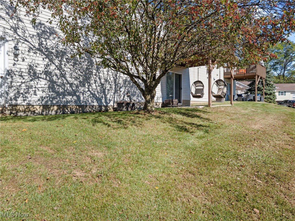 64 River Ridge Lane Munroe Falls, OH 44262 - Photo 25 of 25 View of grassy yard with a patio area and a deck