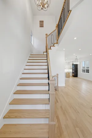 a view of entryway and hall with wooden floor