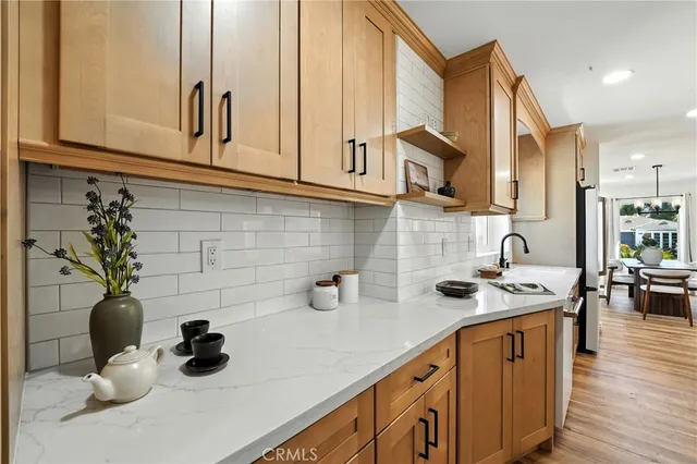 a kitchen with a sink appliances and cabinets
