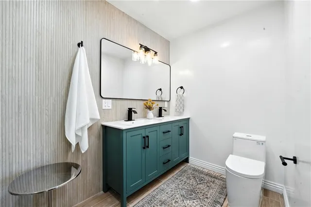 a bathroom with a sink toilet and mirror