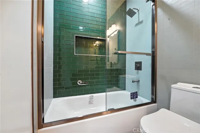 a bathroom with a toilet and bathtub
