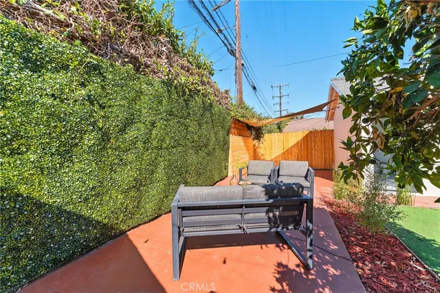 a backyard of a house with table and chairs