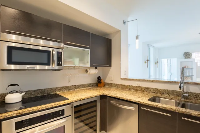 a kitchen with a sink and a stove top oven