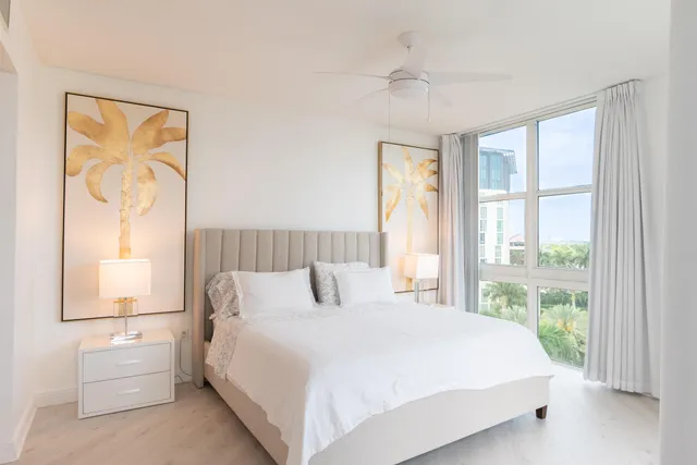 a bedroom with a large bed and a window