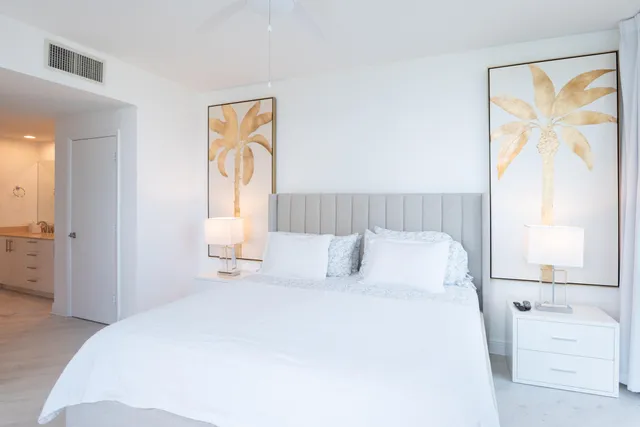 a bedroom with a bed and a painting on the wall