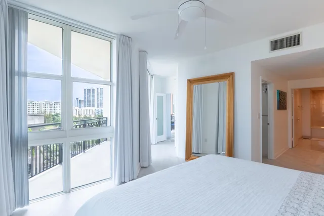 a bedroom with windows and entrance