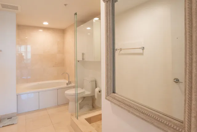 a bathroom with a bathtub a toilet and a shower