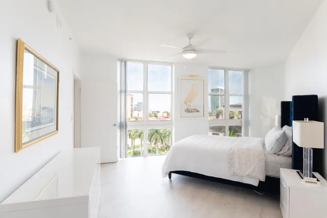 a bedroom with a bed and glass window