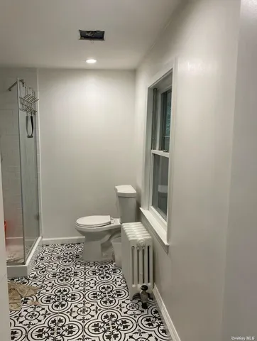 a bathroom with a toilet and a shower