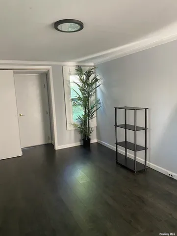 a view of a room with wooden floor and window