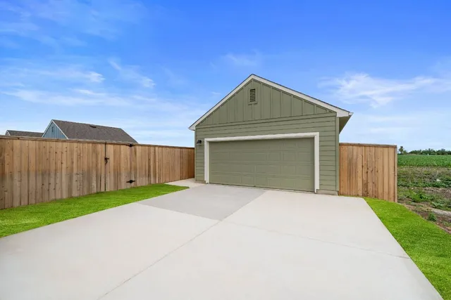 an aerial view of a house with a garden and lake view