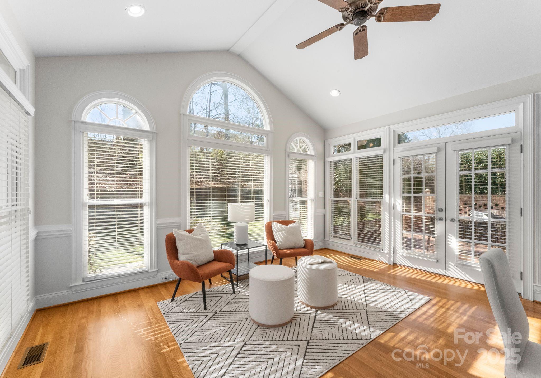 1604 Windy Ridge Road Charlotte, NC 28270 - Photo 14 of 39 a living room with furniture and floor to ceiling windows