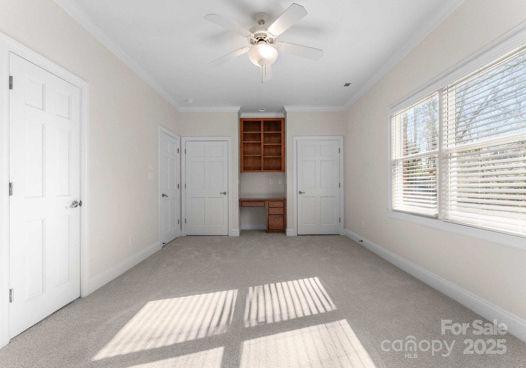 1604 Windy Ridge Road Charlotte, NC 28270 - Photo 21 of 39 a view of a bedroom with a ceiling fan and a window