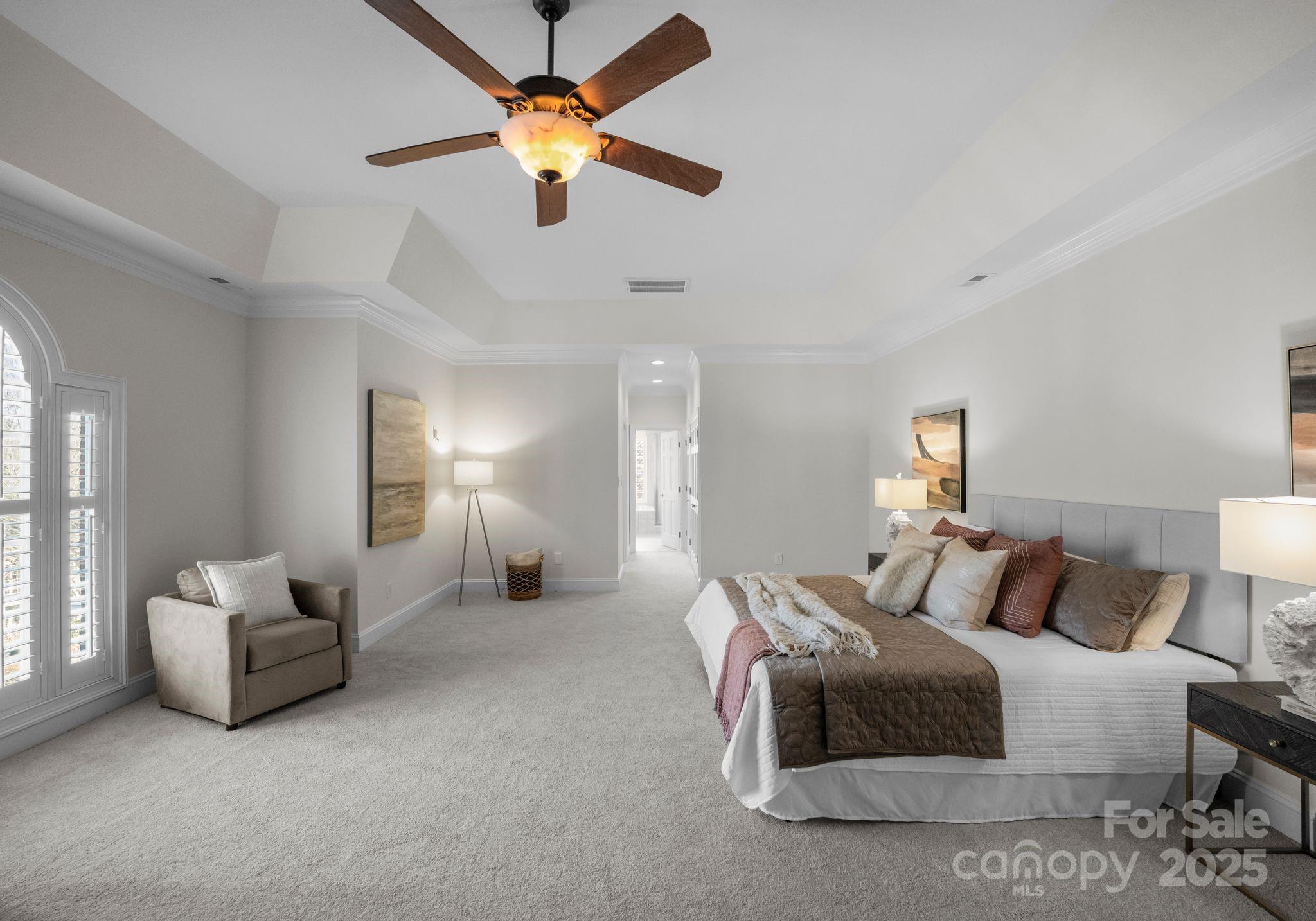 1604 Windy Ridge Road Charlotte, NC 28270 - Photo 23 of 39 a bedroom with bed and a chandelier