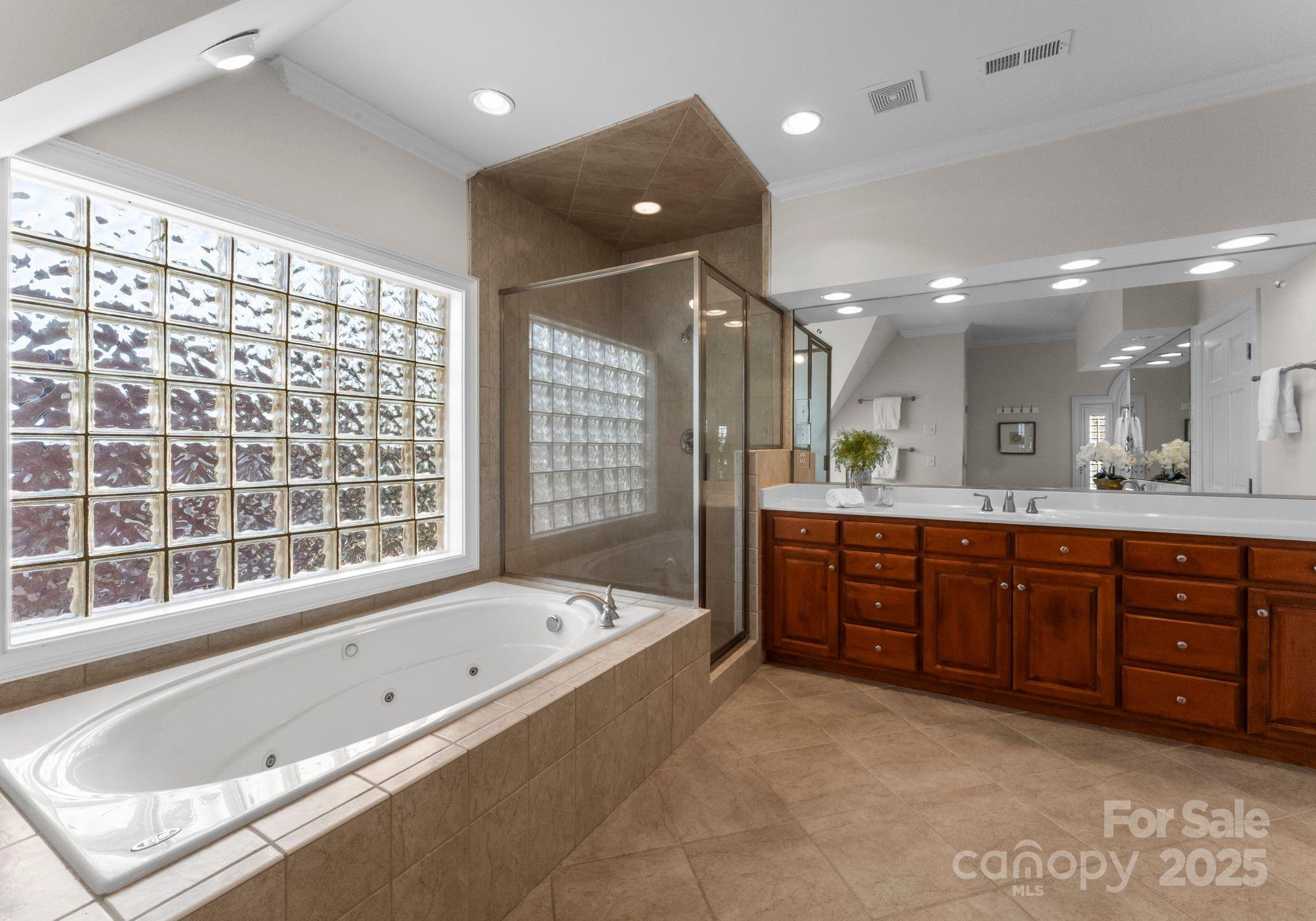 1604 Windy Ridge Road Charlotte, NC 28270 - Photo 27 of 39 a bathroom with a tub a sink double vanity and shower