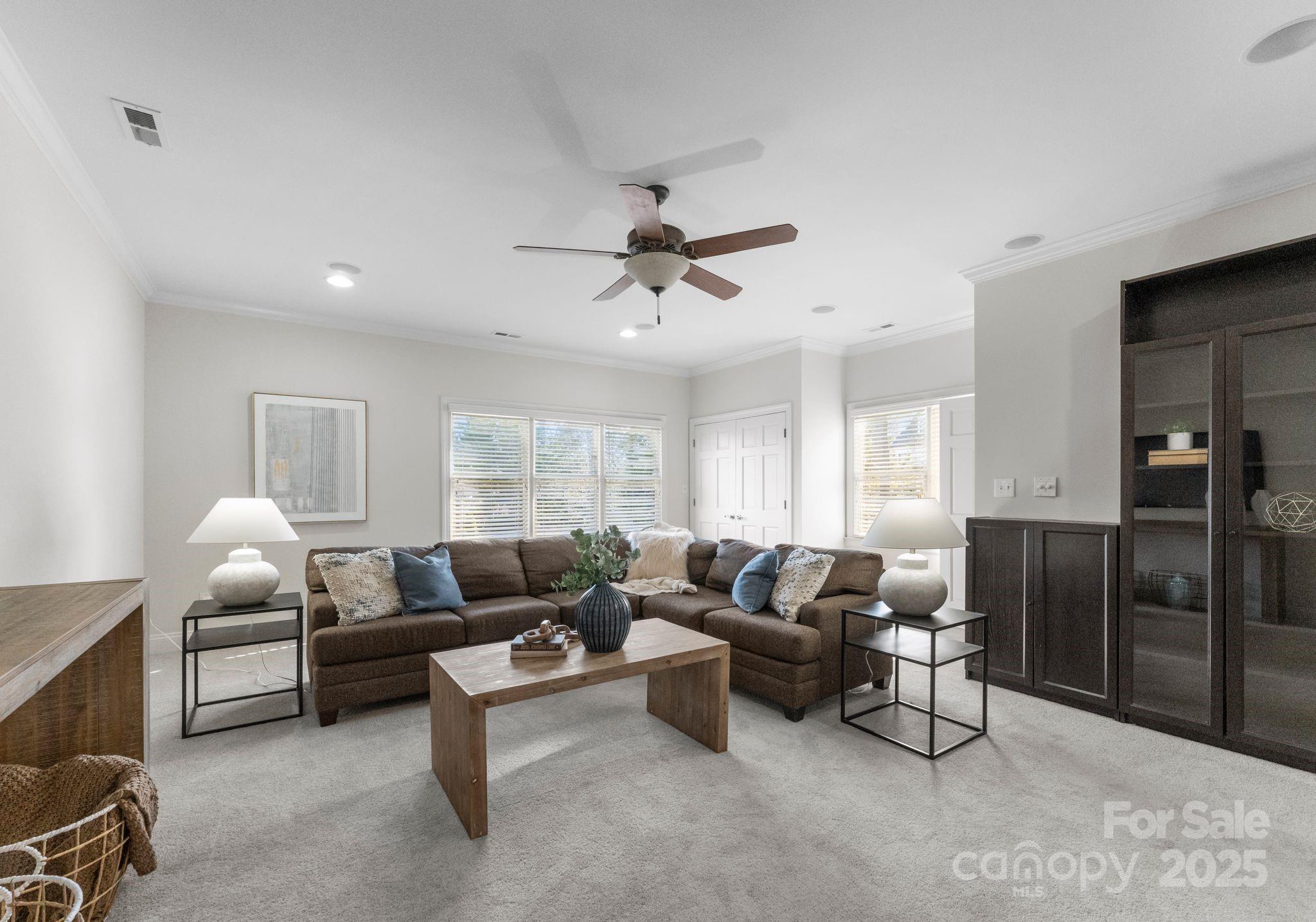 1604 Windy Ridge Road Charlotte, NC 28270 - Photo 29 of 39 a living room with furniture ceiling fan and a window