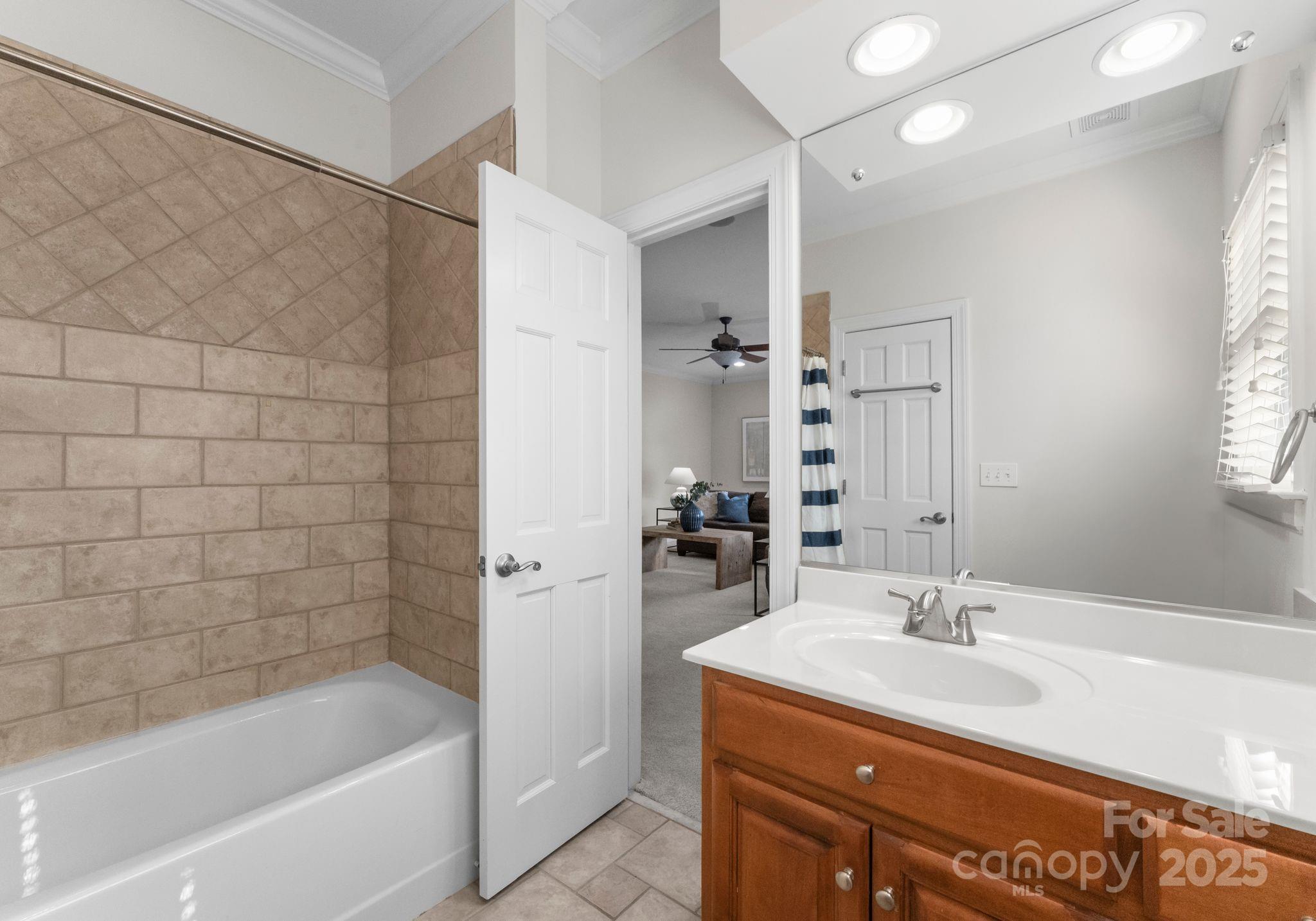 1604 Windy Ridge Road Charlotte, NC 28270 - Photo 30 of 39 a bathroom with a bathtub sink vanity and mirror