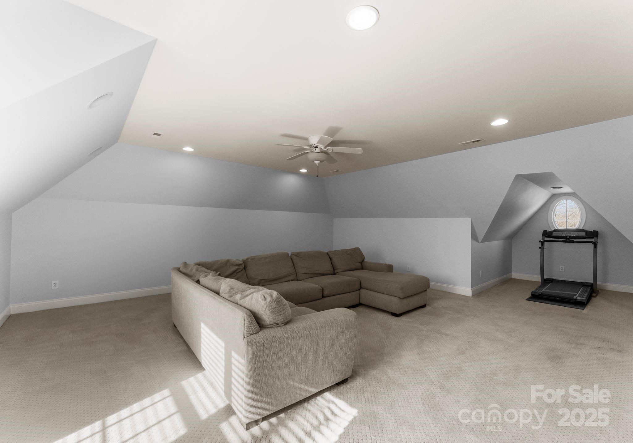 1604 Windy Ridge Road Charlotte, NC 28270 - Photo 31 of 39 a living room with furniture and a ceiling fan