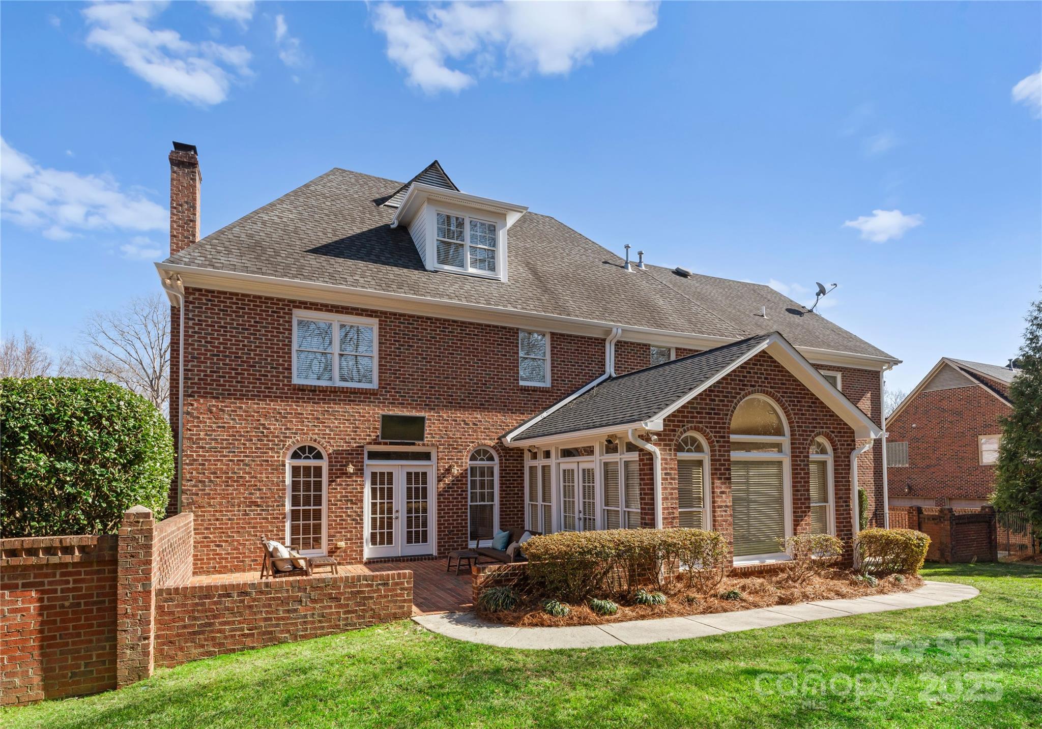 1604 Windy Ridge Road Charlotte, NC 28270 - Photo 35 of 39 a front view of a house with a yard and potted plants