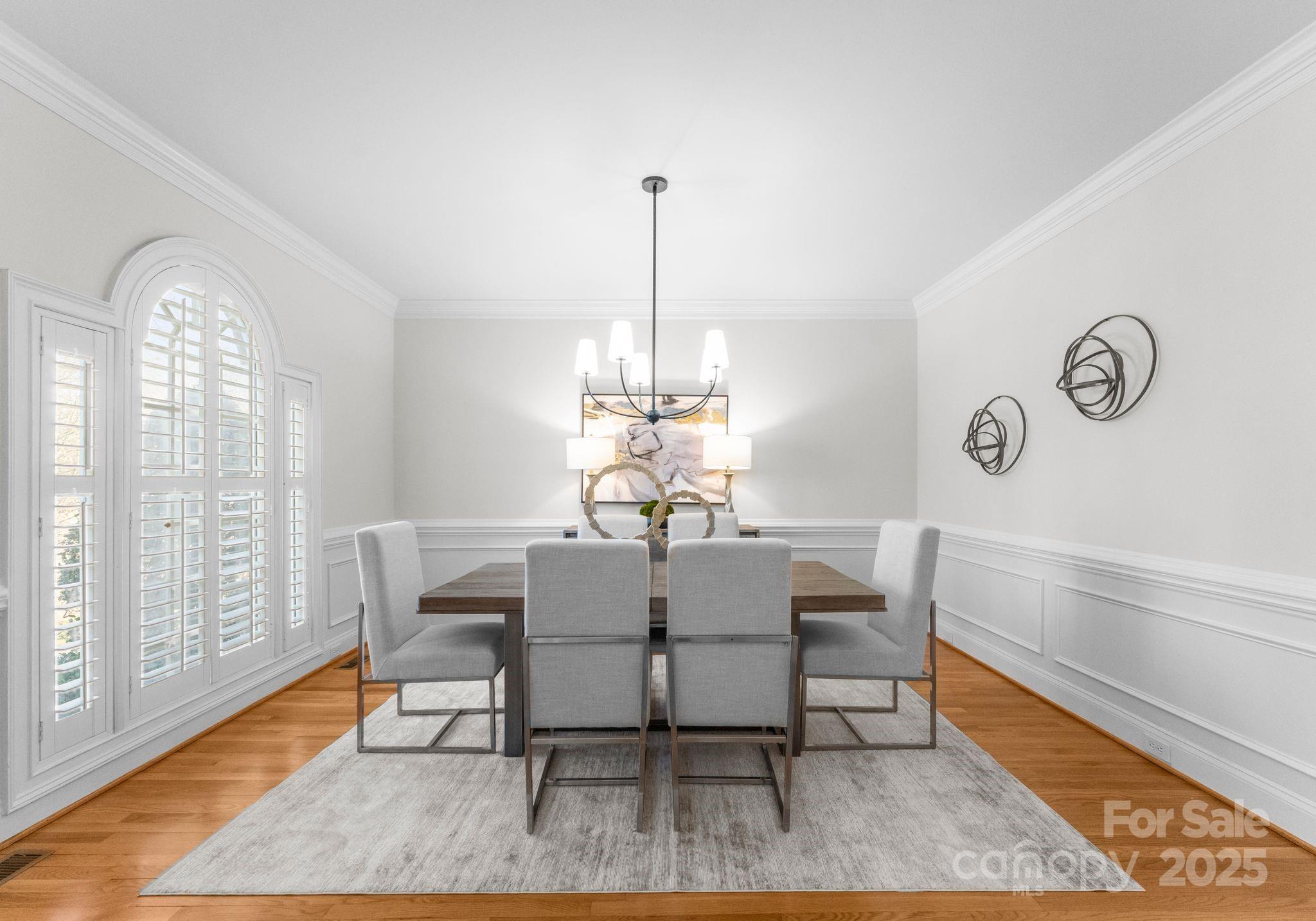 1604 Windy Ridge Road Charlotte, NC 28270 - Photo 8 of 39 a dining room with furniture a chandelier and wooden floor