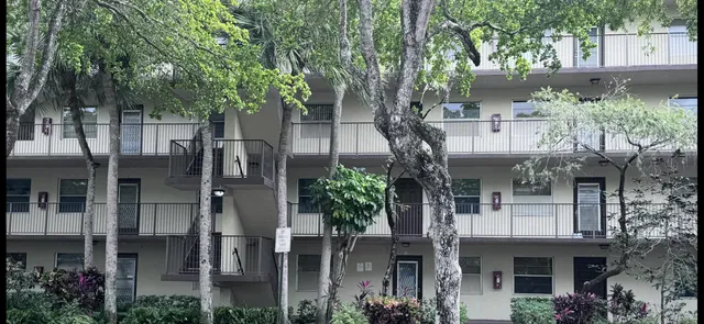 a front view of a house with plants