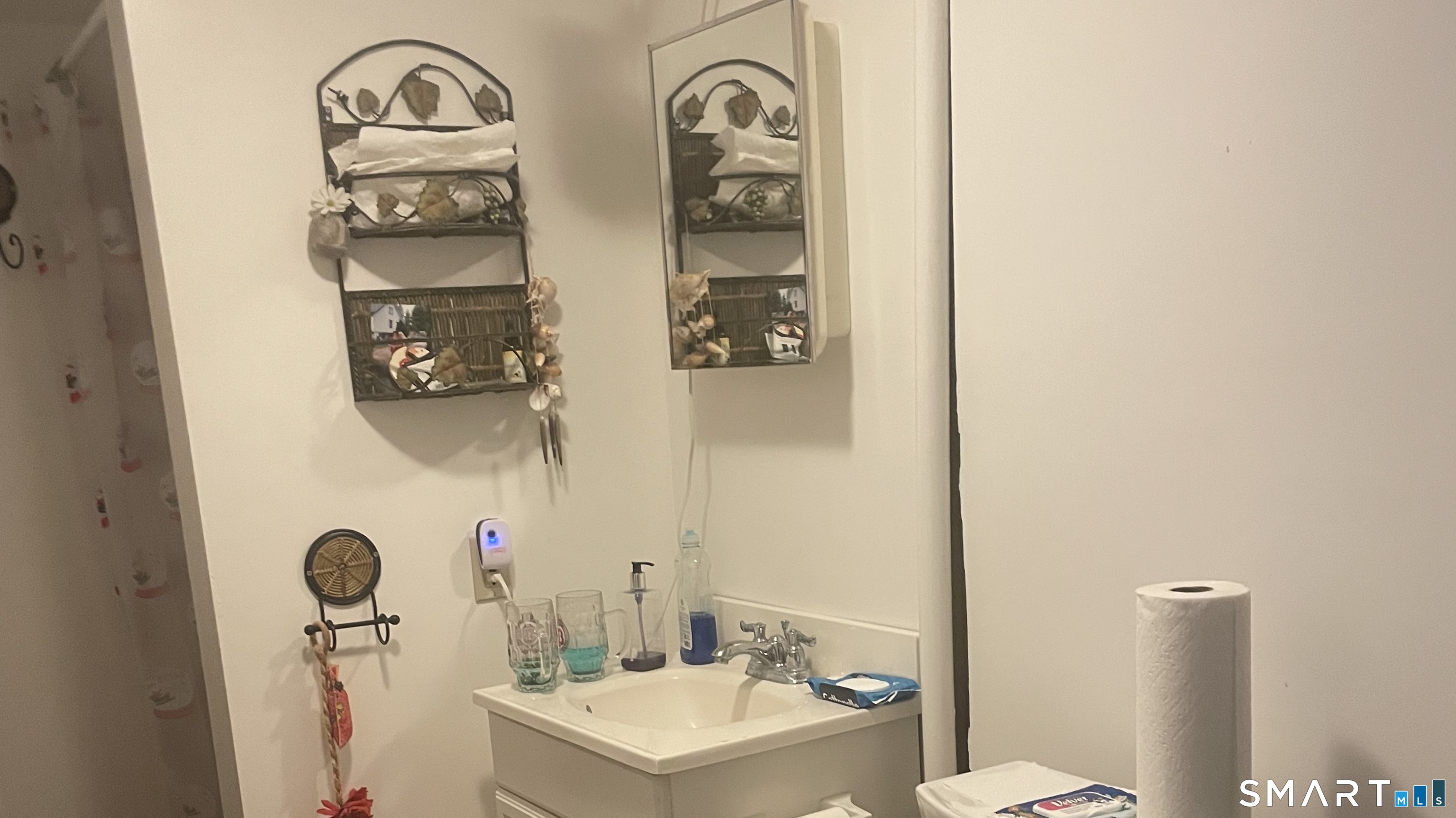 260 South Grand Street Suffield, CT 06093 - Photo 11 of 12 a bathroom with a sink a toilet and a mirror
