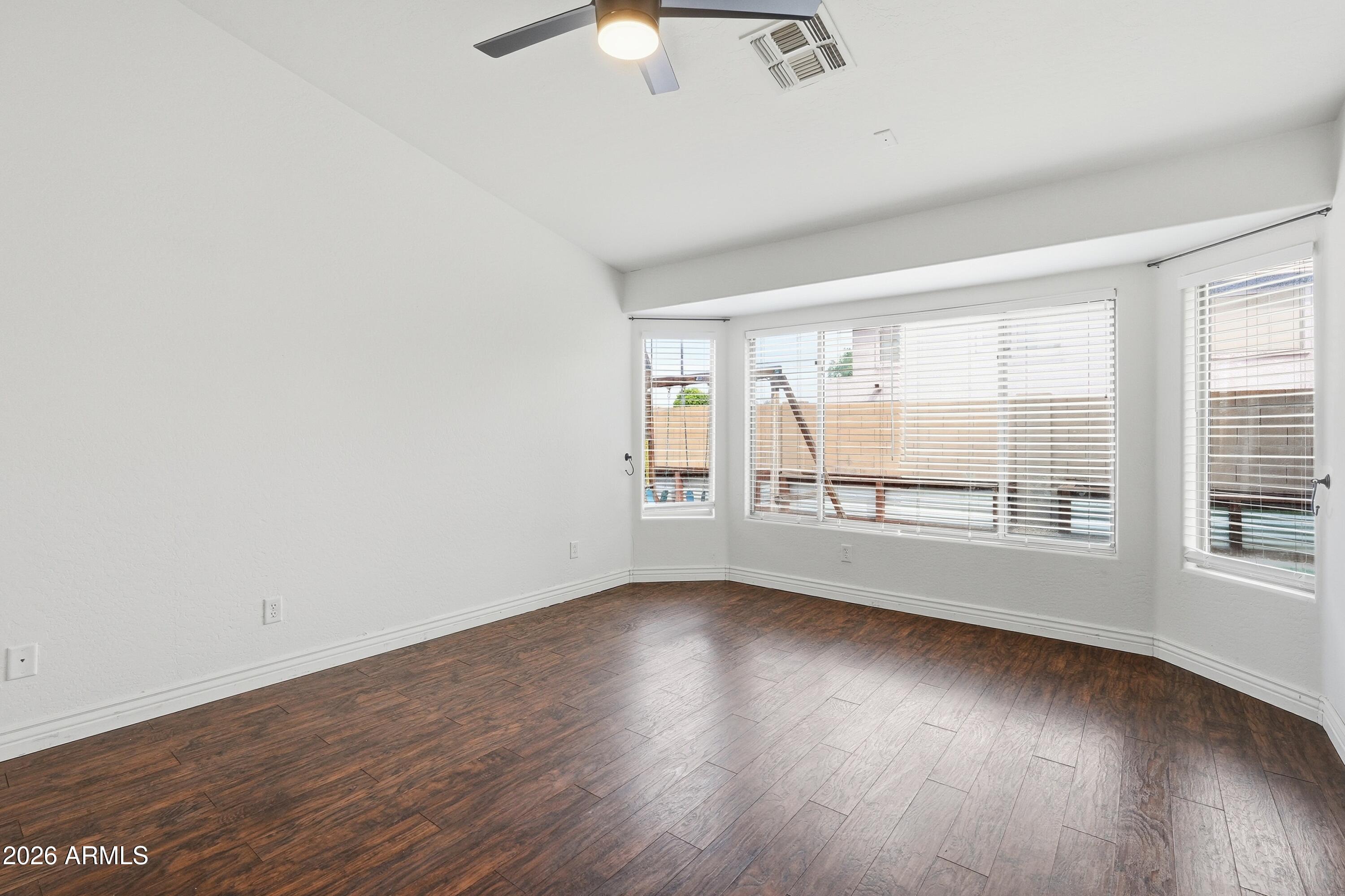 3242 East Bonanza Road Gilbert, AZ 85297 - Photo 13 of 36 an empty room with wooden floor and windows